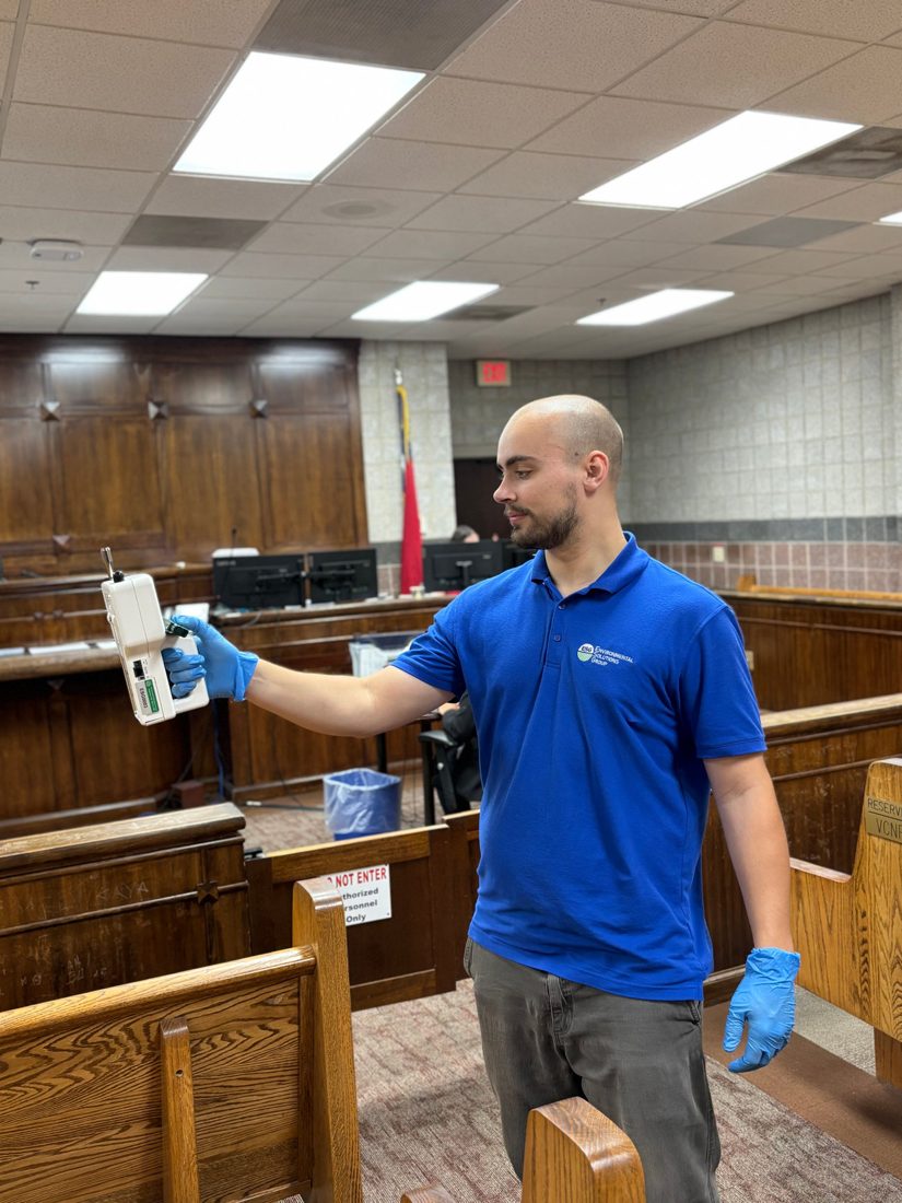 ESG inspector running air sampling equipment inside a commercial building in the Piedmont Triad