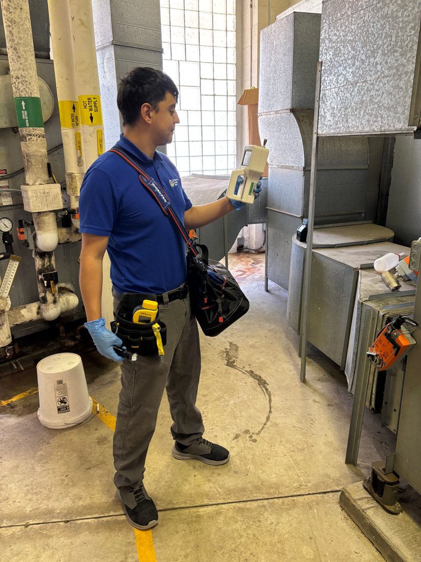 ESG field technicians carrying testing equipment on an active North Carolina construction site
