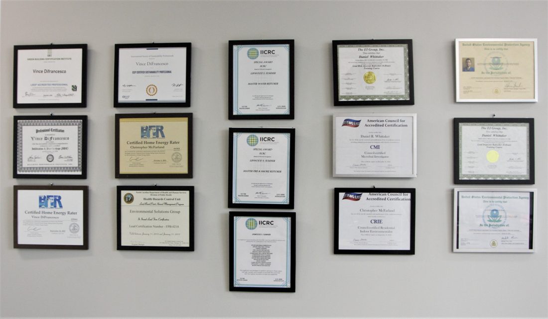 Framed professional certifications displayed on the wall at ESG's Greensboro, NC office