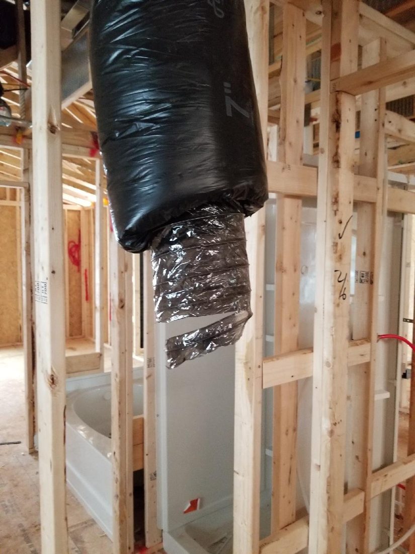 Exposed ductwork and framing inspected before drywall installation