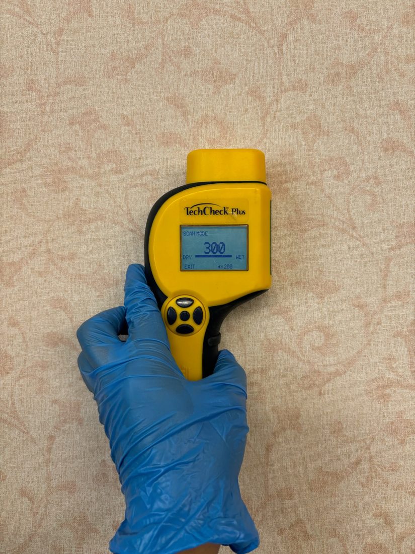 Infrared thermometer used to check framing surface conditions